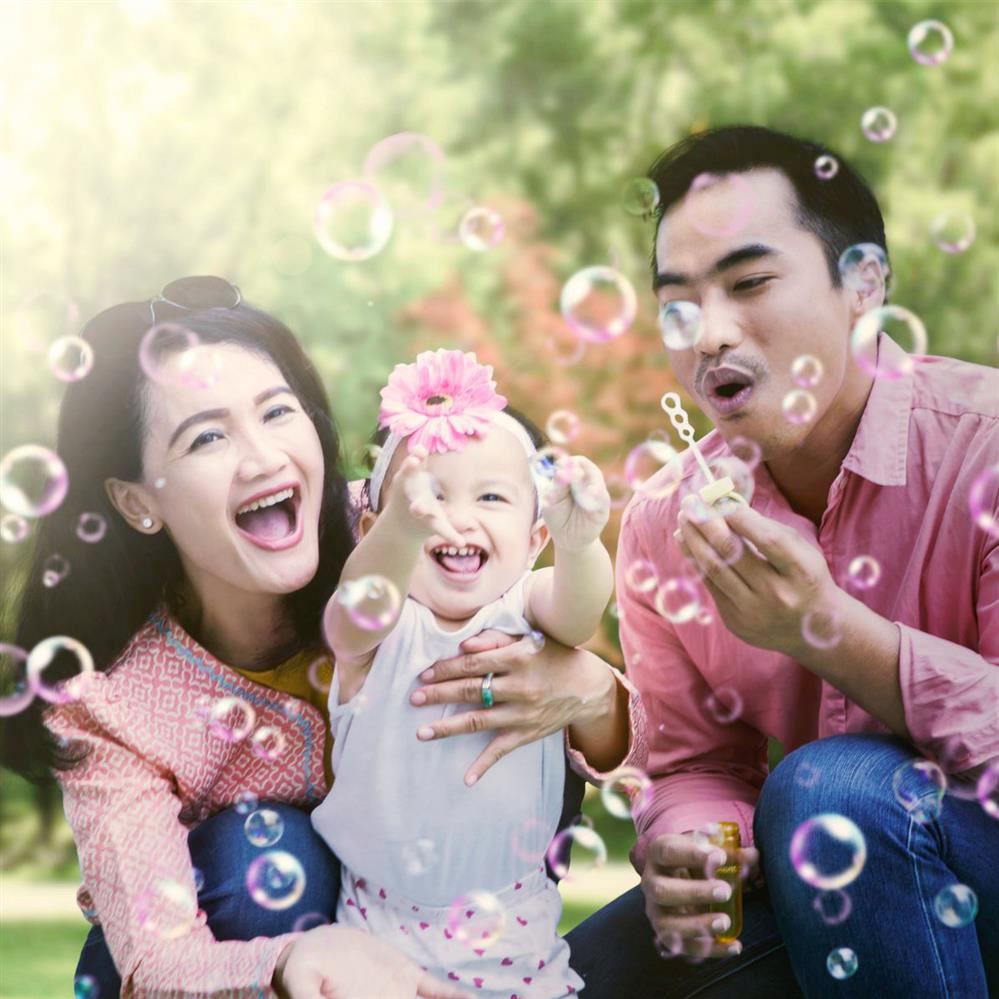  Family blowing bubbles outside